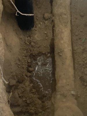 Trench with old sewer pipe leaking