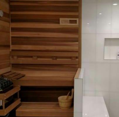 Side-by-side steam shower and custom sauna.