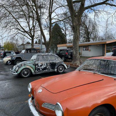 Enjoying the view of a VW and VW Karmann Ghia with my donut