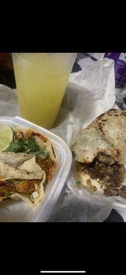 2 chicken tacos and a steak burrito with the pineapple jarrito drink.