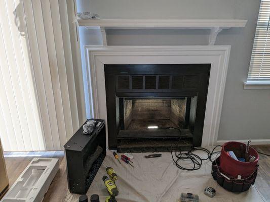 Pre-fab fireplace being prepared for an electric insert.