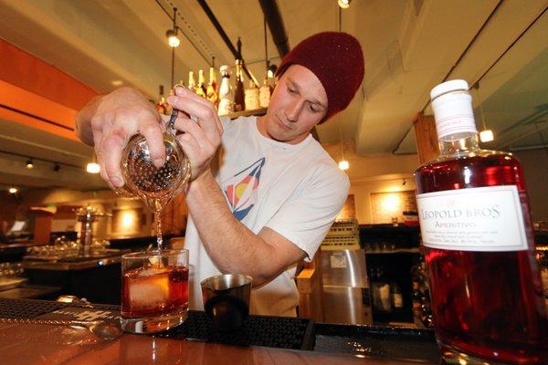 Bartender at co. bar Frisco, Colorado pouring a drink