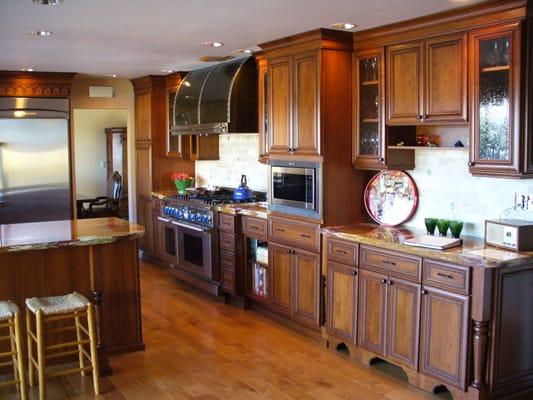 Moroccan inspired kitchen in Woodland Hills, CA using Semi Custom Cabinets, seeded glass, onyx counters & travertine splashes