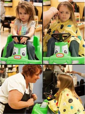 From uncertainty to a big smile for this big sister during her first haircut.