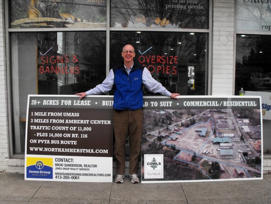 Sean, the owner, displaying some large format poster printing with foamcore and lamination!