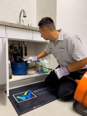 Check out Joshua working hard to unclog this kitchen's drain and pipes.