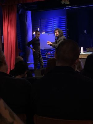 Magician Ritchy Flo onstage with audience member.