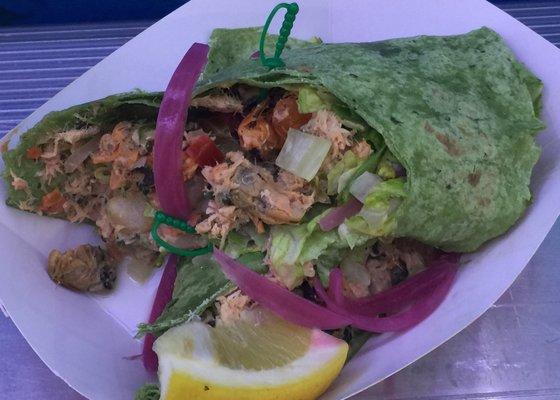 Seafood Wrap - zesty blend of fresh shrimp, mussels, clams & salmon in a spinach tortilla with lettuce, tomato, onion & lemon