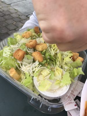 The yummy Caesar salad they replaced my taco for. Don't know why there's a hand in the photo. $7without chicken