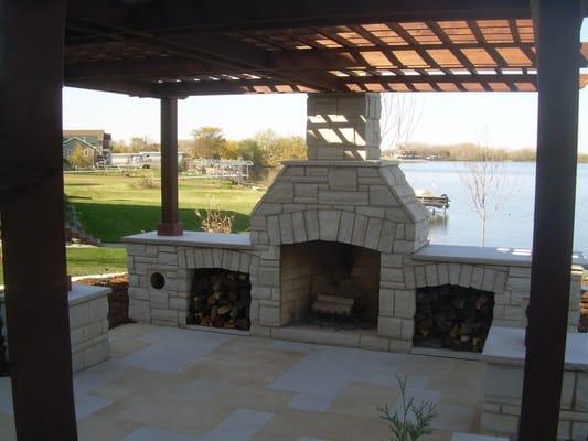 Natural stone fireplace with a nice cedar pergola.