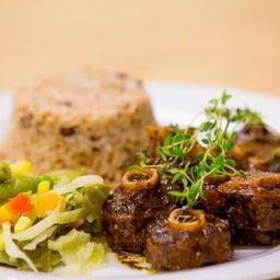 Oxtail with rice & peas and steamed vegetables.