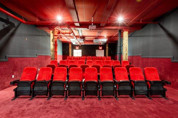 Our 72 seating screening room with red velvet seats and industrial features has a classic movie theater feel perfect for your next event.