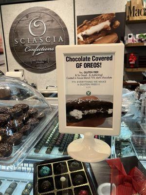 Sign on chocolate case advertising chocolate covered GF Oreos