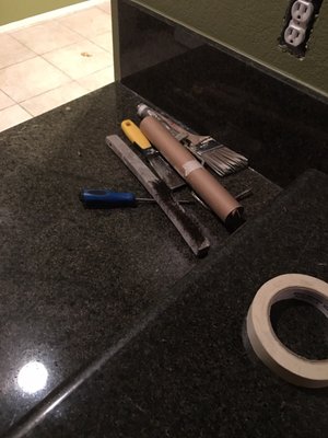 Some tool sitting on the countertop that he did not rape or put a dropcloth.