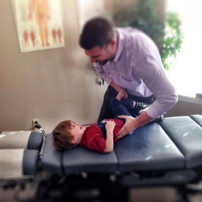 Dr. Matt carefully adjusting his son, Harrison when he was three years old.