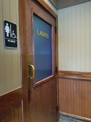 Ladies is to the right of the hostess station. Gents to the left.