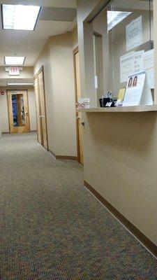 The check-in desk and hallway to office entry door.