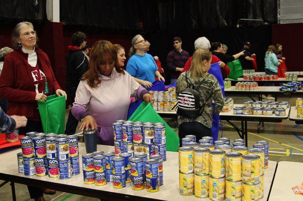 Volunteers at Bethel Baptist Church pack backpack meals at a packing event.