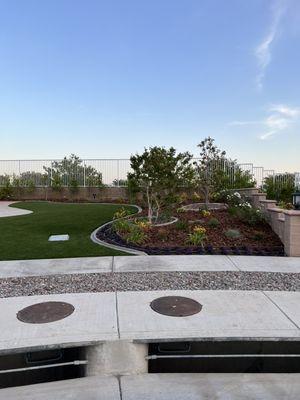 Landscape Design- Put down turf, and along the side added in wood chips & new plants