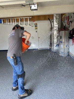 Throwing flake for an epoxy floor in a garage.