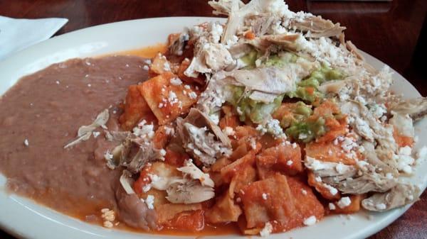 Chilaquiles on the more traditional side (no egg) but with chicken, guacamole, crema.