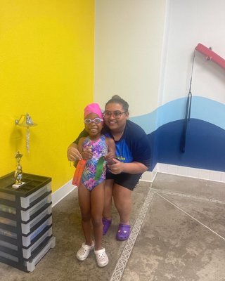 A picture of my Granddaughter and her Swim Coach