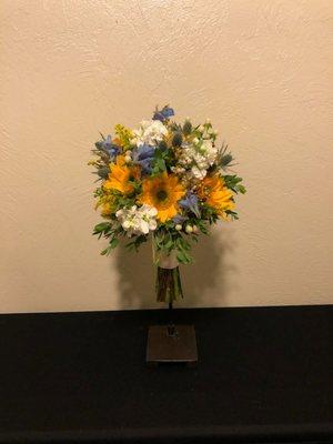 Beautiful bridal bouquet with yellow centered sunflowers, delphinium, thistle, white stock and hypericum berry. Love the eucalyptus accents!