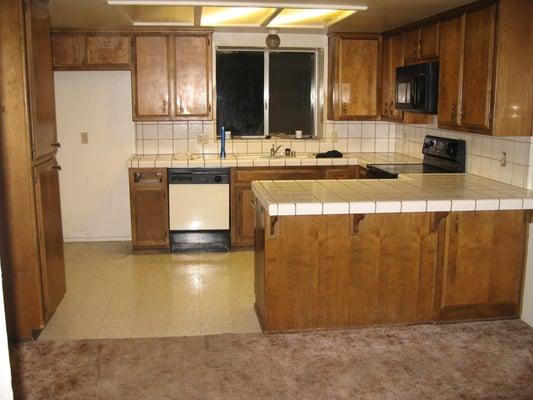 Dated kitchen with lowered ceiling.