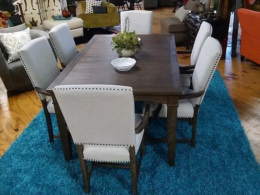 A rustic transitional dining room set with a stunning blue shag carpet.