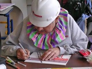 Thunder-Sky drawing in his signature hard hat and clown collar