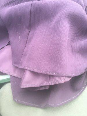 Hem line on the dress, and evidence it was not cleaned.