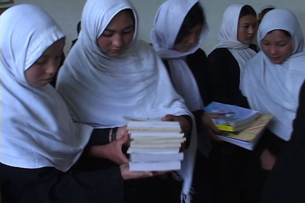 School girls unpack books for their first school library. Kapisa Province, Afghanistan