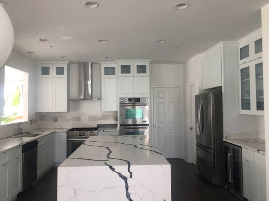 New white cabinets, new island, freshly painted white walls