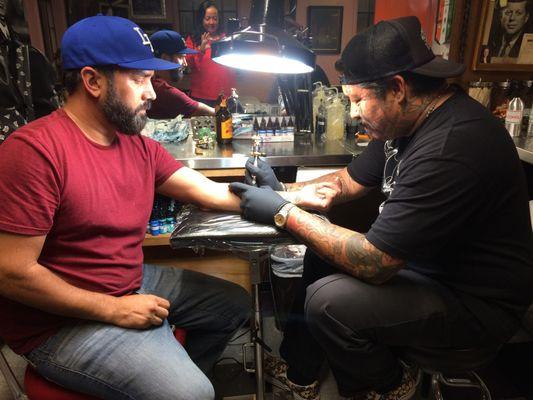 Tattooing professional BMXer, Hollywood Stuntman, Mike Escamilla.