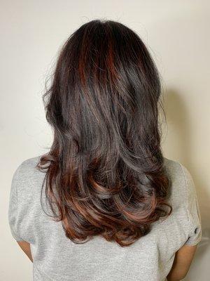 Red highlights and long layers haircut