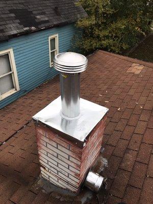 I made a top plate for this chimney housing and extended flue pipe and new cap.