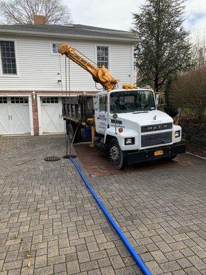 Cleaning a storm drain of leaves and other debris from residential homes driveway