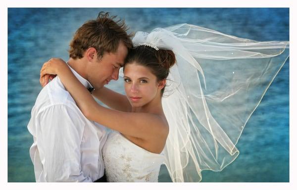 The beach is a great location for a wedding. Always fun and full of surprises like this veil blowing in the wind!