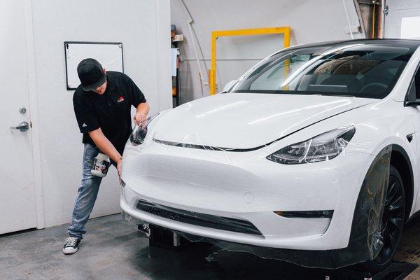 Chase installing a clear bra package on a Tesla.