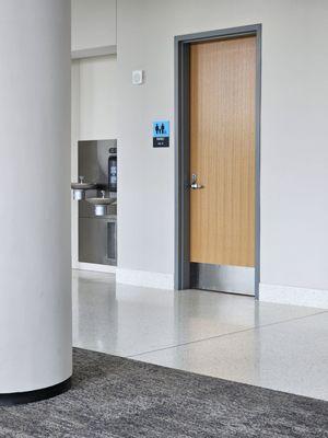 Family restroom & water fountain with water bottle refill station.