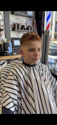 Kids haircut with scissor texture and a skin tight fade.