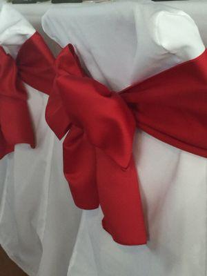 White chair cover with red satin sash