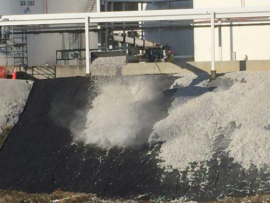 Placing stone on slopes at Marathon Petroleum Tri-State Tank Farm in Kenova, WV