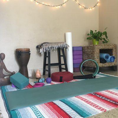 Cozy home studio with yoga mats, props, and therapeutic tools to enhance your experience