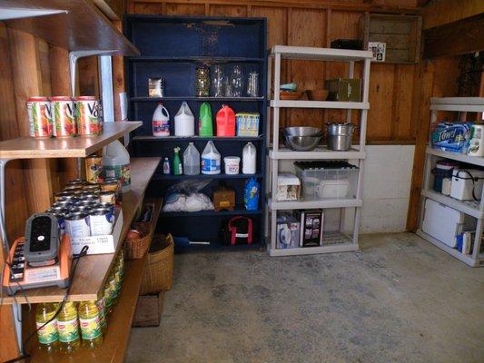 Storage after placing shelves to store laundry, cleaning, 'Costco' overflow.