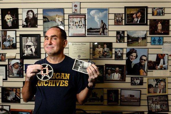 PP owner Rob Hoffman stands in front of a wall filled with slides and negatives scanned by the company.