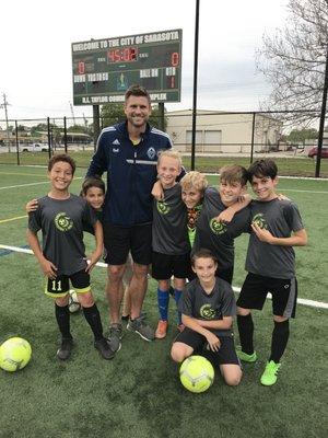 Coach Brad Rusin with a few team members at practice