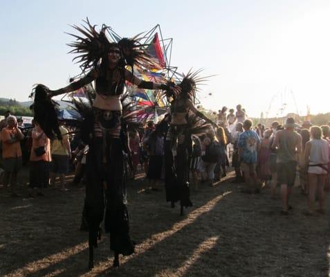 Stilt-walkers interacting with the crowd at the Oregon Country Fair.