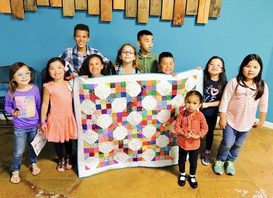 A quilt that was created and pieced together by the Sunday school children and will be donated to Shriners Hospital for a sick child.