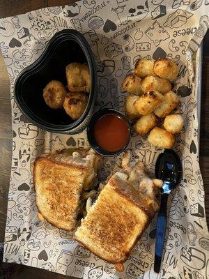 The best of both worlds sandwich (short rib & mac and cheese) w/ tater tots Side of signature mac bites ( heart shaped bowl)